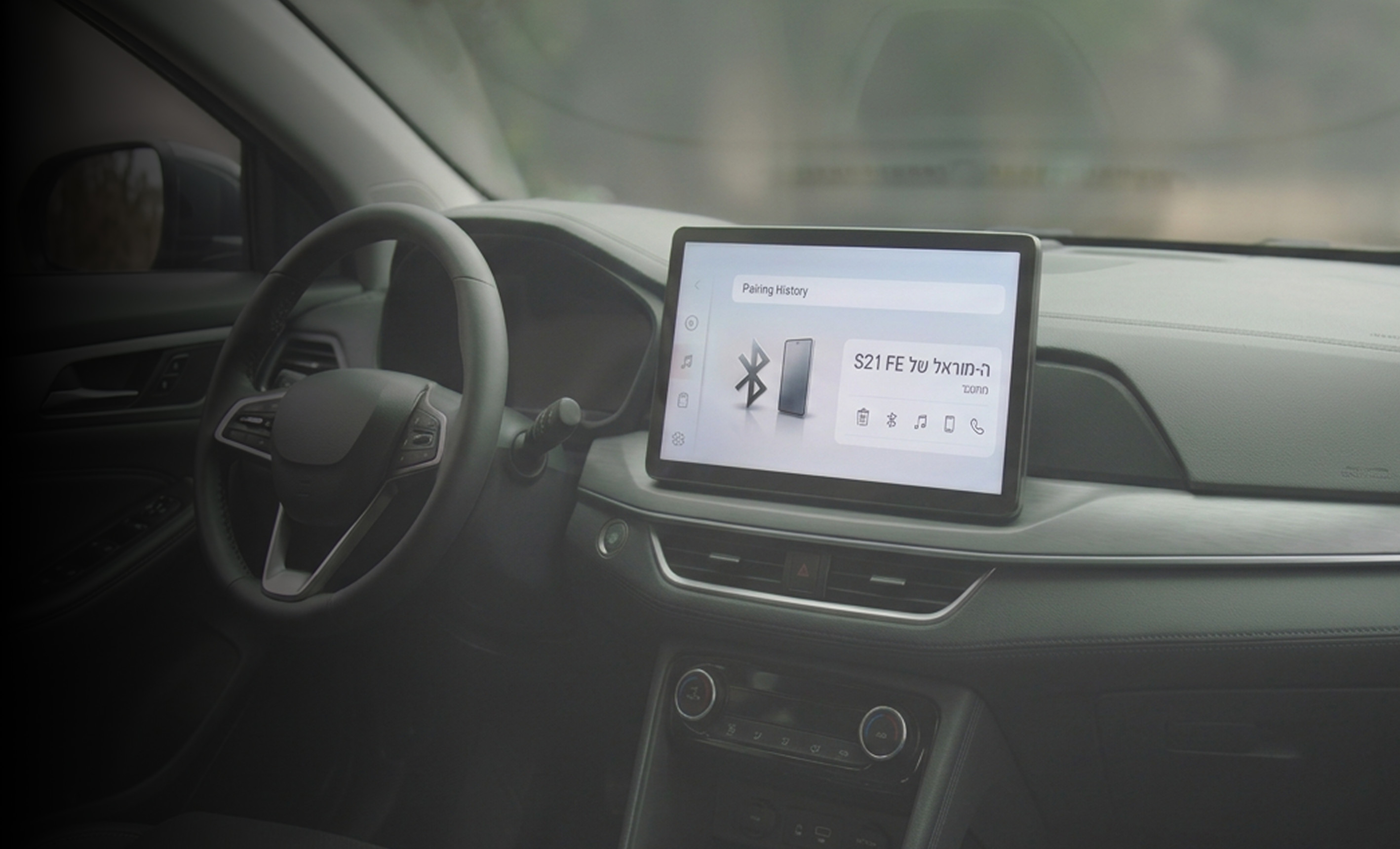 A car dashboard whose Bluetooth screen lists the paired phone as “S21 FE's Morel”