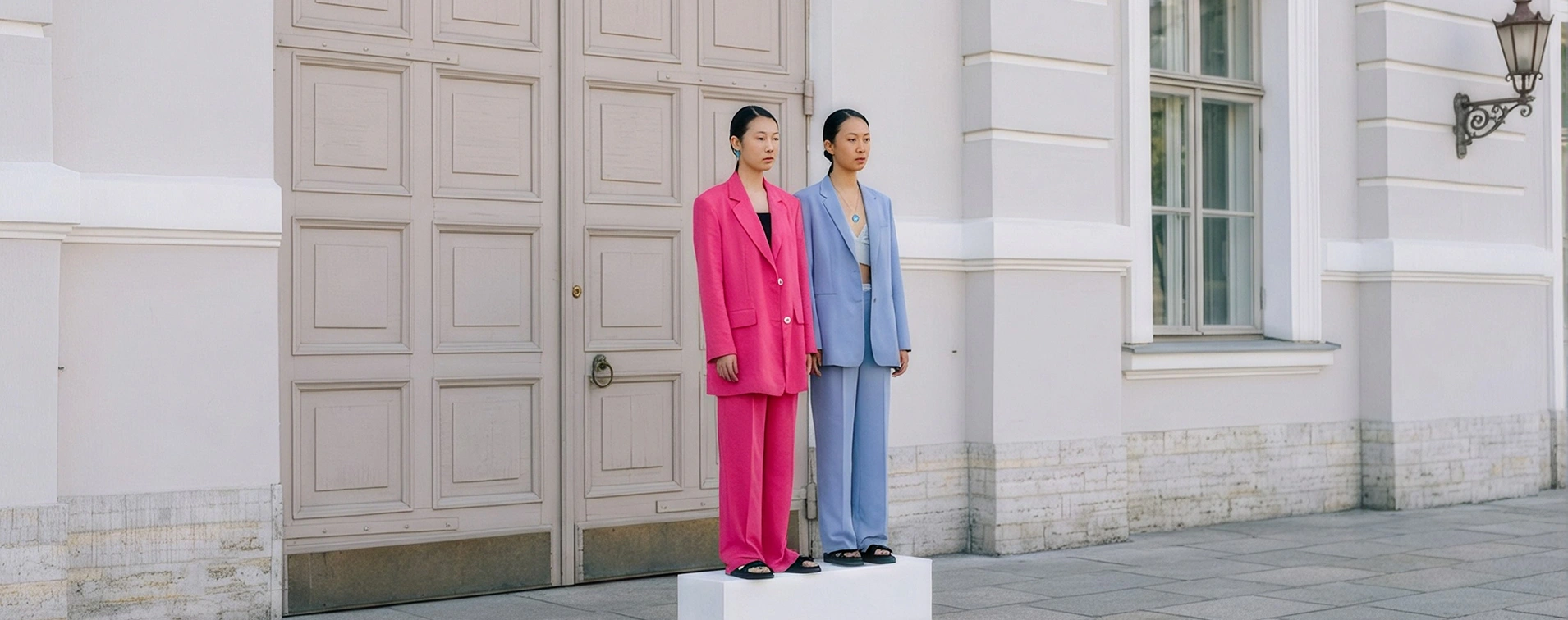 Fashion campaign featuring two models in pink and blue